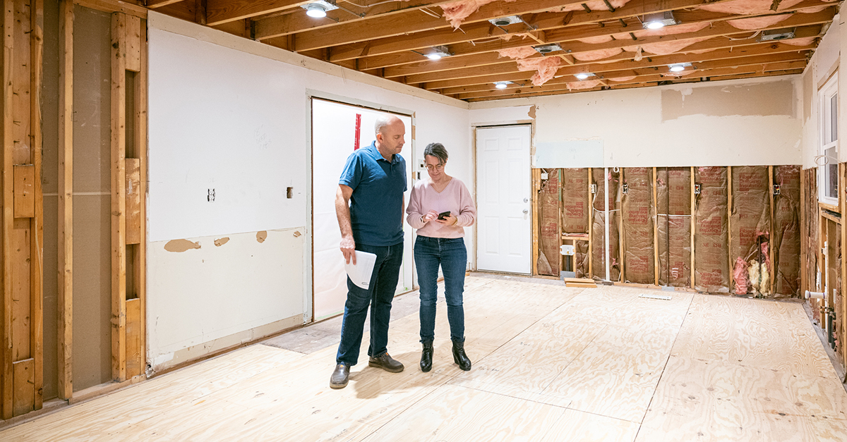A couple looking at renovation plans for their home