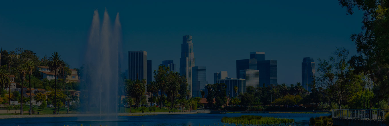 Progressive Title Company city skyline behind fountain in river